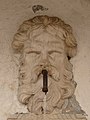 Detail of mascaron on the fountain in Oltrecastello