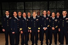 Members of the United States Coast Guard pose for a photo in service dress blue uniforms. U.S. Coast Guardsmen with the 8th Coast Guard District pose for a photo in their service dress blue uniforms in New Orleans April 3, 2013 130403-G-LB304-157.jpg