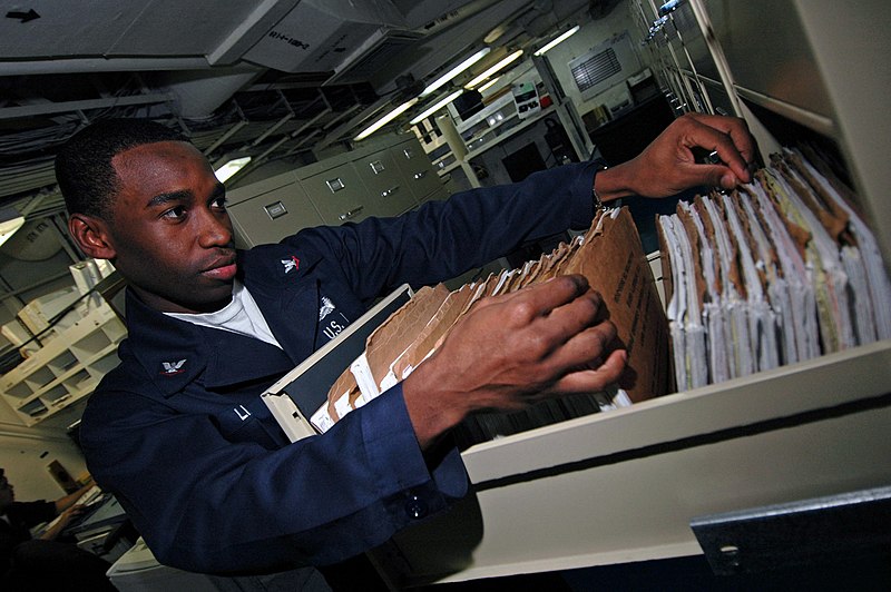 File:US Navy 071124-N-0167B-022 Personnel Specialist 3rd Class Cameron Casan Lino sorts through service records in the personnel office aboard the aircraft carrier USS Kitty Hawk (CV 63).jpg