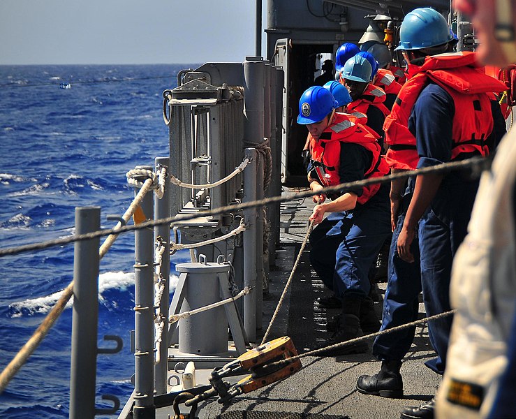 File:US Navy 090128-N-4774B-043 Sailors ) heave in the line attached to the span-wire during a replenishment at sea.jpg