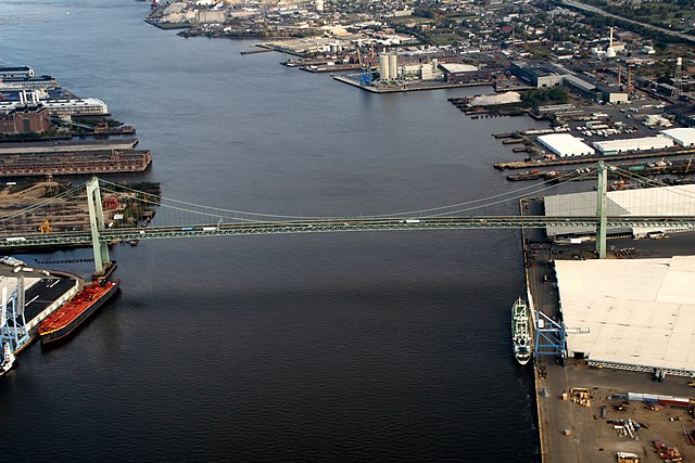 Walt Whitman Bridge crossing the Delaware River with port facilities of Camden-Gloucester at right and Philadelphia at left