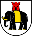 En plata, al alumnado elefante negro del campamento, defendido, clavado y gualdrapado de oro y que sostiene una torre roja abierta y acristalada del segundo (Hilfikon, Suiza)