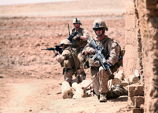 U.S. Marines with Golf Battery, 2nd Battalion, 10th Marine Regiment (2/10) set up security and await an explosive ordnance disposal team during a patr