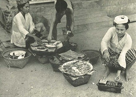 Sunggi or bakul satay seller ladies grilling satay in Lombok
