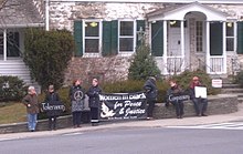 Women in Black staging a protest in front of Elting Memorial Library