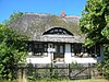 Typical thatched ''Fischland'' house with a holiday flat (