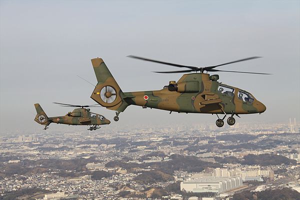 A pair of OH-1s in formation flight