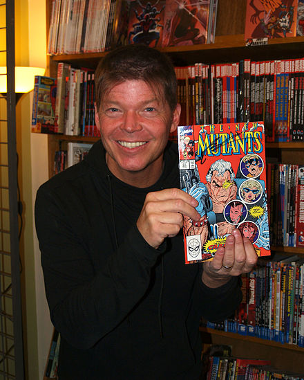 The character's co-creator, Rob Liefeld, holding up a copy of New Mutants #87, in which the character made his first full appearance
