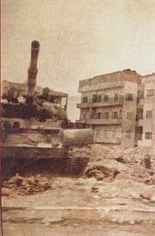 A Syrian army tank rolls over the ruins of the city suburbs shortly after the 1982 Hama massacre, which killed an estimated 40,000 civilians After Hama Massacre 26.jpg