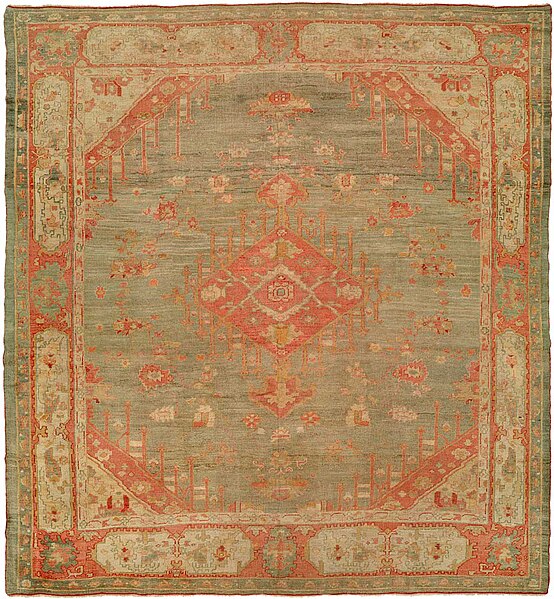 File:Antique oushak carpet with a pale red and green tone.jpg