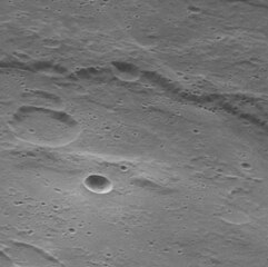 Oblique view of circular bright crater within Manley