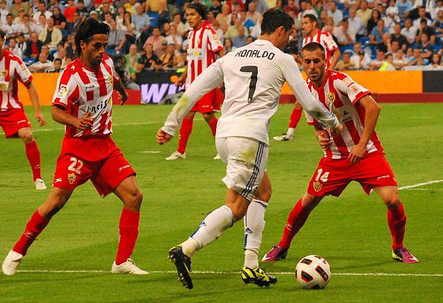 UD Almería players facing Real Madrid's Cristiano Ronaldo in 2011
