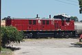 A maroon-colored locomotive with a black roof