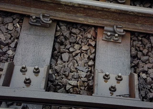 Track ballast supports railway sleepers, which carry railway track.