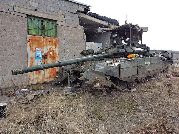 An abandoned and damaged Russian T-72B3M tank with improvised top-mounted slat armor during the 2022 Russian invasion of Ukraine at Mariupol