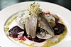 A fancy serving of herring at a restaurant