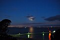 Eclipsed moon casts an orange moon beam over Port Phillip Bay.