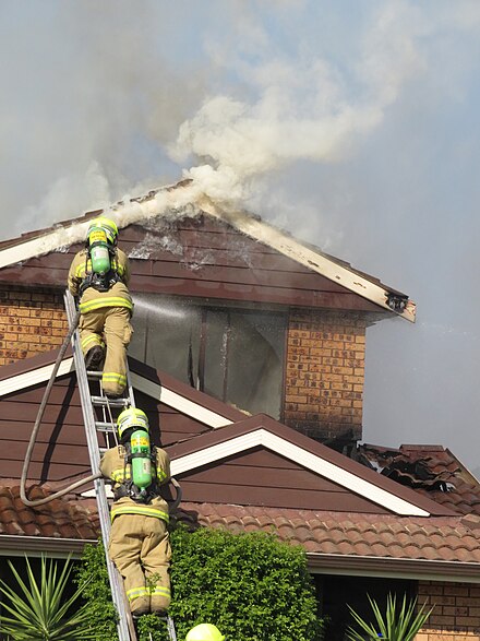 FRNSW firefighters scale a ladder to extinguish a house fire FRNSW Firefighters House Fire.jpg