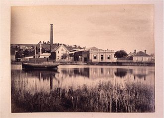 The gasworks from across the North Esk before the construction of the levee system Gas works from North Esk Launceston.jpg