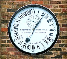 The Shepherd Gate Clock at the gates of the Royal Greenwich Observatory. This clock shows Greenwich Mean Time all year round, ie. it is not set to British Summer Time in the summer. Greenwich clock 1-manipulated.jpg