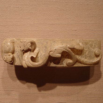 A jade-carved sword scabbard slide with a dragon design, from the Western Han Era