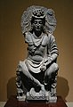 Maitreya, nun tronu al estilu occidental, con un devotu Kushan. Sieglu II Gandhara.