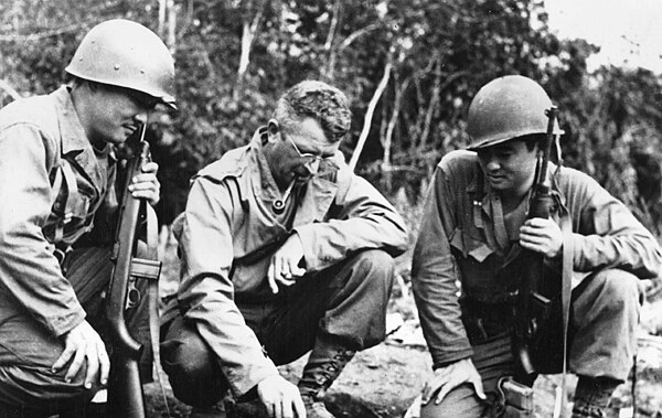 Frank D. Merrill (center) explains battle situation to L. Herb Miyazaki and R. Akiji Yoshimura, interpreters for 3rd Battalion 5307th, Burma, 1944