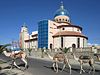 A camel train passes the new Church of San Antonio in the center of Keren