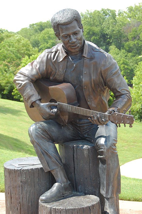 "Otis Redding Sittin' on the Dock of the Bay", statue in Gateway Park by Bradley Cooley and Bradley Cooley, Jr of Bronze By Cooley, 2003