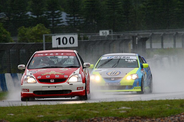 Paul Poon leads Kenneth Look in the rain at ZIC during a Hong Kong Touring Car Championship race.