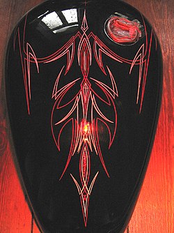 Pin striping on a motorcycle fuel tank. Pinstriping.jpg