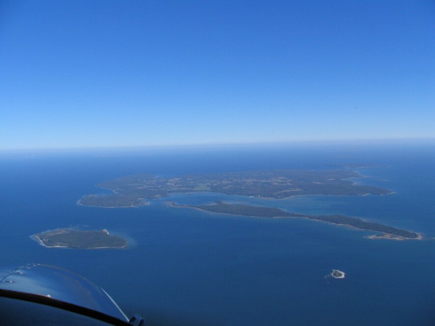 Pilot Island is the small island at the lower right, with the larger Plum Island is at the lower left. Above Pilot Island is the long and narrow Detroit Island, with Washington Island in the distance. Plum Island Pilot Island Detroit Island and Southern Washington Island Wisconsin.jpg