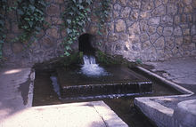 A Kariz surfacing in Niavaran, Tehran. It is used for watering the grounds of The National Library of Iran. Qanat Niavaran.jpg