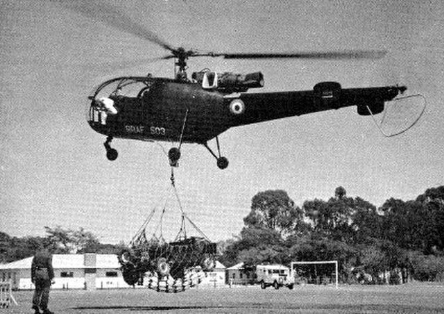 Royal Rhodesian Air Force Alouette III helicopter lifting a short wheelbase Mini Moke in 1962.