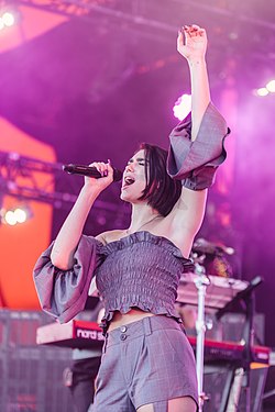 Colour picture of Dua Lipa performing during her tour