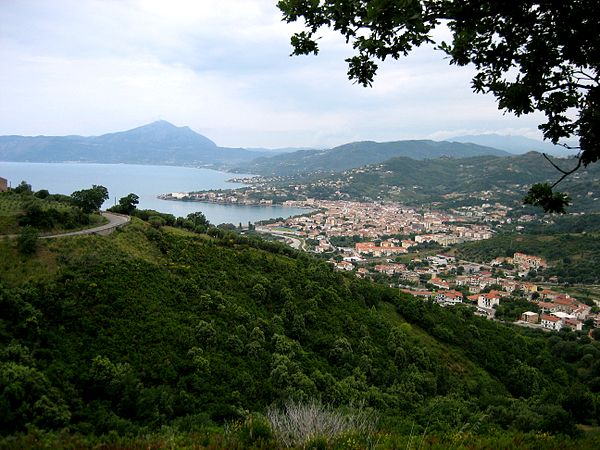 Panoramic view of Sapri; the railway track is visible on the side of the hill; it reaches the station in the background on the right after a wide curv