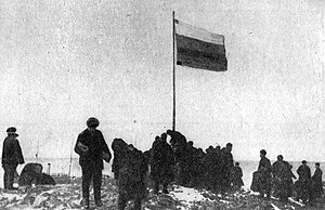Raising of the Russian flag at Cape Berg during the 1913 Arctic Ocean Hydrographic Expedition.