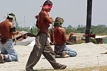 Self-flagellation is ritually performed in the Philippines during Holy Week (on Good Friday, before Easter). Striding flagellant.jpg
