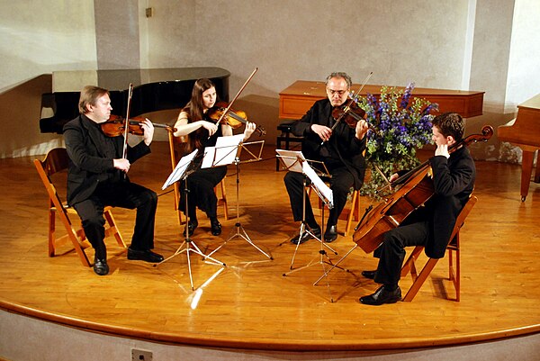 A string quartet in performance. From left to right: violin 1, violin 2, viola, cello