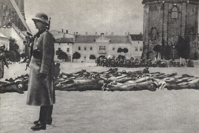 The Bloody Wednesday Olkusz 1940. German soldier guarding prone men of Olkusz on 31 July. The picture has been described as "known to everyone in Olku