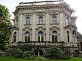 Villa with fence including gate pillars and resting place