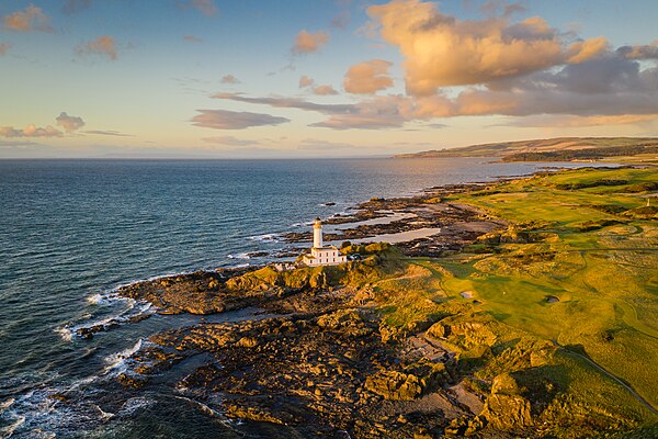 Turnberry lighthouse at sunset surrounded by the golf course.