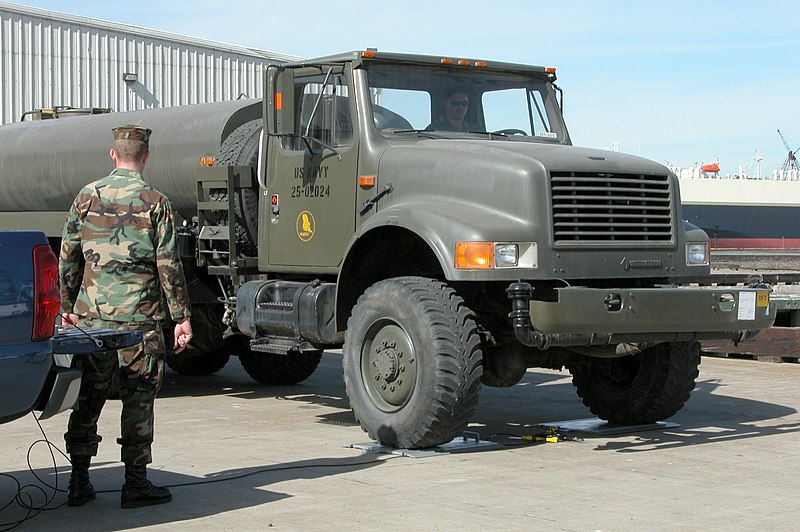 File:US Navy 050124-N-4397B-001 A Seabee, assigned to Naval Mobile Construction Battalion One (NMCB-1), weighs a water truck.jpg