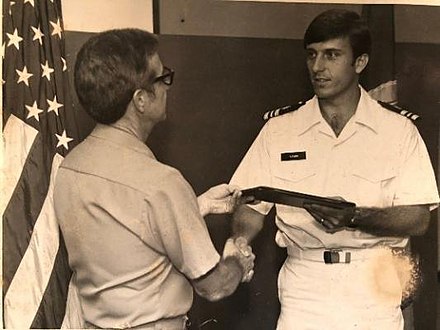 LCDR Fleming receives award while serving in the Navy.