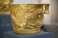 Photo of a gold mug depicting a bull