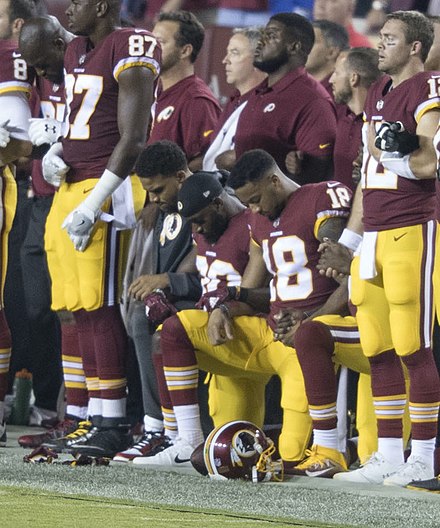 Washington Redskins players kneeling before a game against the Oakland Raiders in September 2017