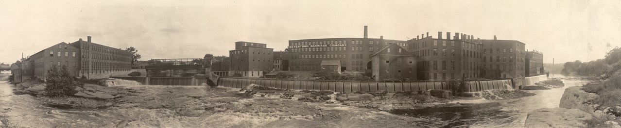 Three factories on elevated ground above the Black River