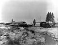 The pilot of a C-47 cargo transport crash lands safely after having dropped supplies to elements of the 101st Airborne Division which has successfully repulsed all attempts to capture the besieged city of Bastogne, Belgium. 30 Dec 1944