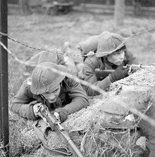 Infantrymen of Le Regiment de Maisonneuve in a defensive firing position during Exercise Spartan, England, 7 March 1943. A177138-v6.pdf