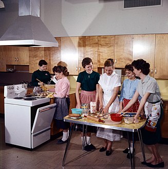 A Home Economics class receiving instructions on cooking. Ottawa, Ontario, 1959.